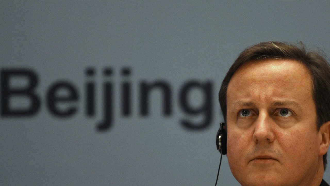 Britain s Prime Minister David Cameron listens at a business summit during a trade mission in Beijing