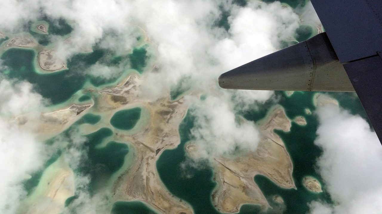 FILE PHOTO: Lagoons can be seen from a plane as it flies above Kiritimati Island part of the Pacific Island nation of Kiribati