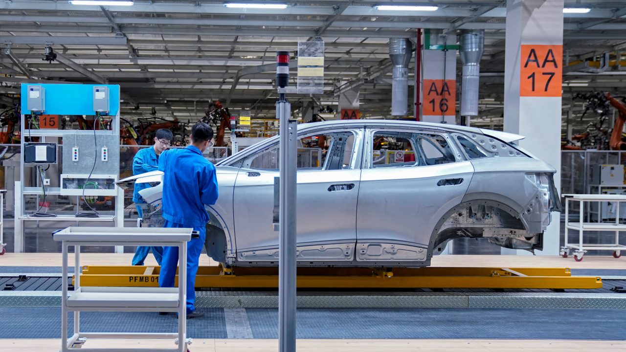 Employees work on assembly line during a construction completion event of SAIC Volkswagen MEB electric vehicle plant in Shanghai
