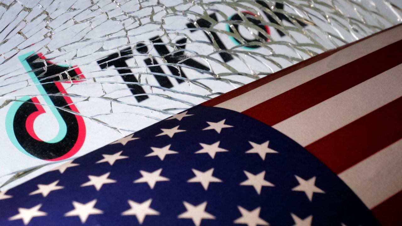 Illustration shows U S flag TikTok logo and broken glass