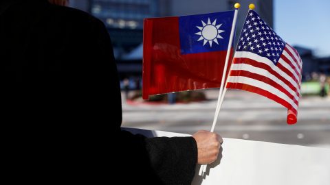 A demonstrator holds flags of Taiwan and the United States in support of Taiwanese President Tsai Ing wen during an stop over after her visit to Latin America in Burlingame
