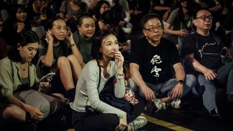 People listen to the speech of a protester as a coalition of civic groups and small political parties hold an all-day rally outside the Legislative Yuan in Taipei on May 21 to protest against plans by the main opposition (Chinese Nationalist Party) KMT and the Taiwan People's Party (TPP) to expand parliamentary powers. (Photo: Yasuyoshi Chiba/AFP)