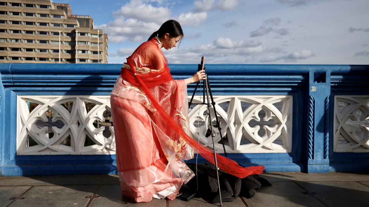 A Chinese student makes a video for her Douyin followers on London’s Tower Bridge on March 25, 2023. (Photo: Kevin Coombs/Reuters)
