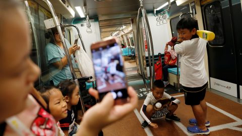 Children pose for a photo inside a sports-themed Mass Rapid Transit (MRT) train in Taipei on August 1, 2017. (Photo: Tyrone Siu/Reuters)