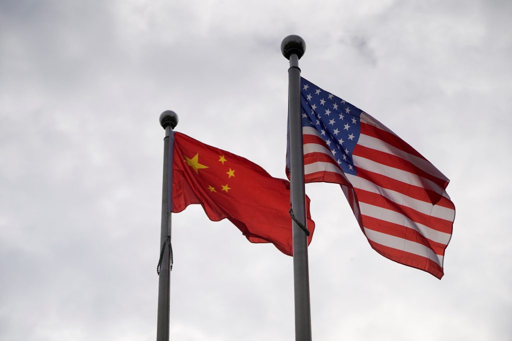 Chinese and U S flags flutter outside a company building in Shanghai