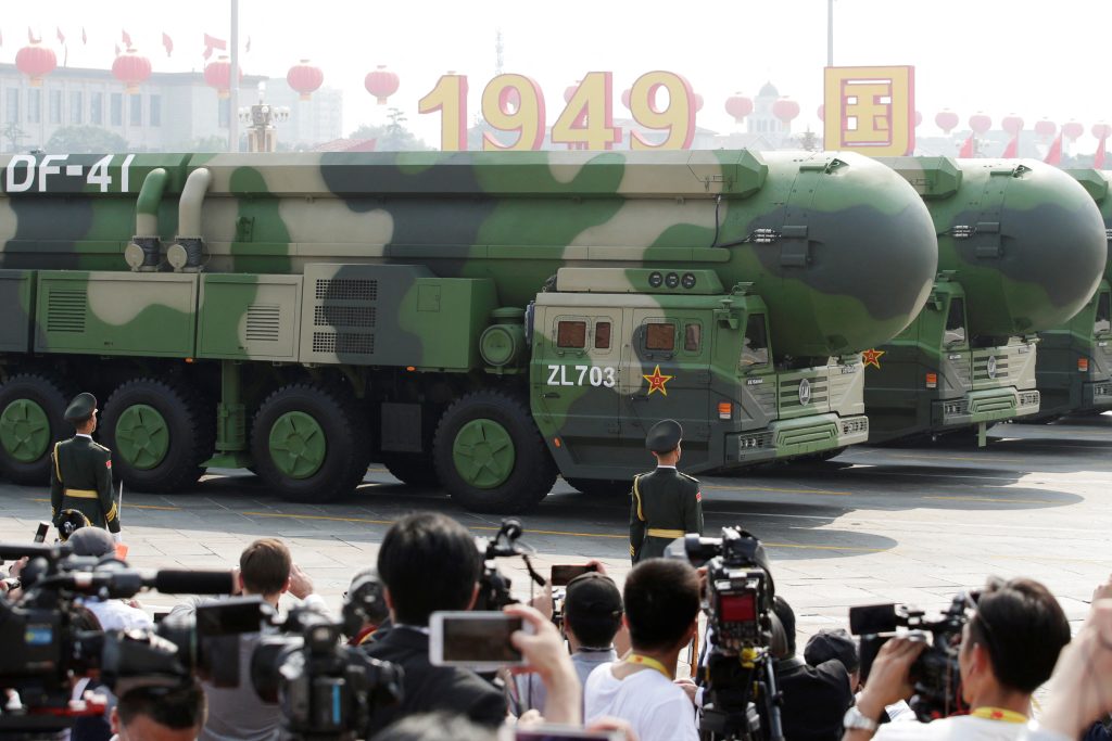 Military vehicles carrying DF intercontinental ballistic missiles travel past Tiananmen Square during the military parade marking the th founding anniversary of People s Republic of China