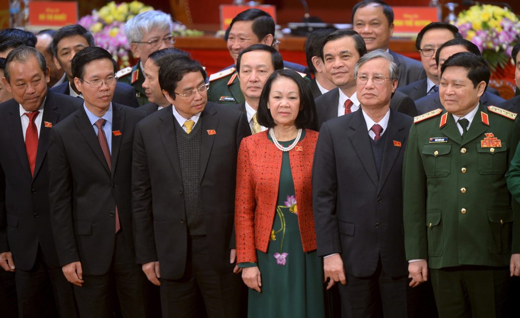 Newly elected Politburo members Truong Hoa Binh Vo Van Thuong Pham Minh Chinh Truong Thi Mai Tran Quoc Vuong and Ngo Xuan Lich pose in Hanoi