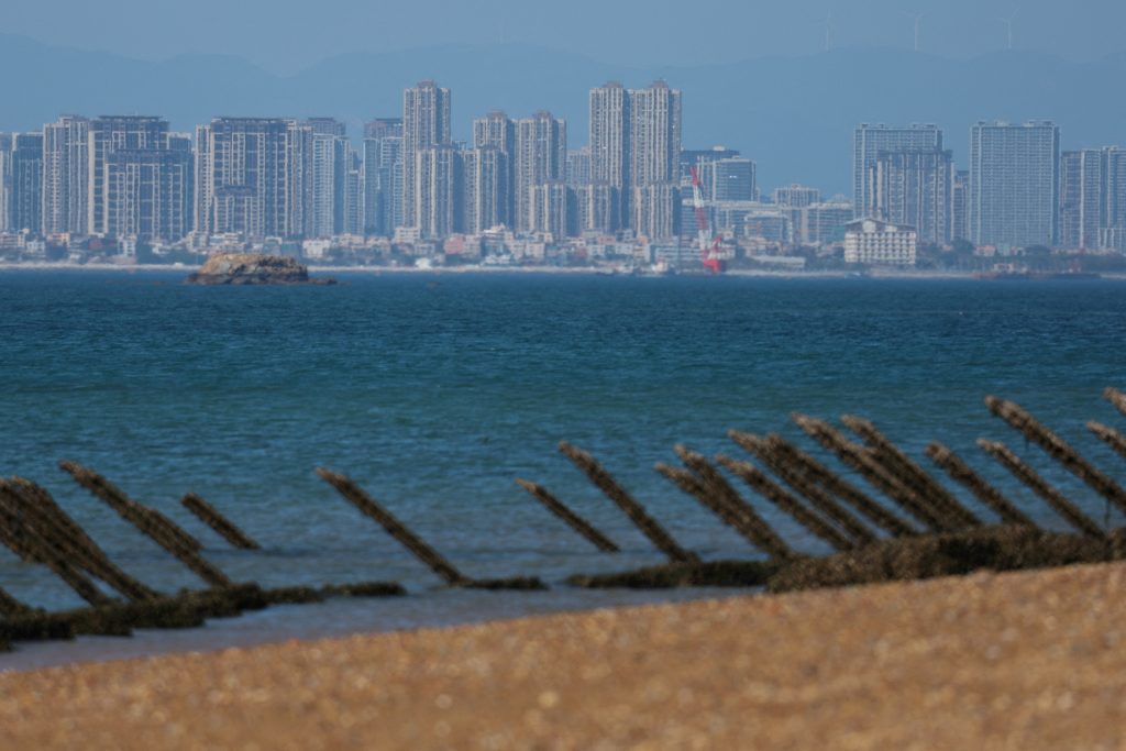 FILE PHOTO: Anti landing barricades are pictured on the beach with China s Xiamen city in the background in Kinmen