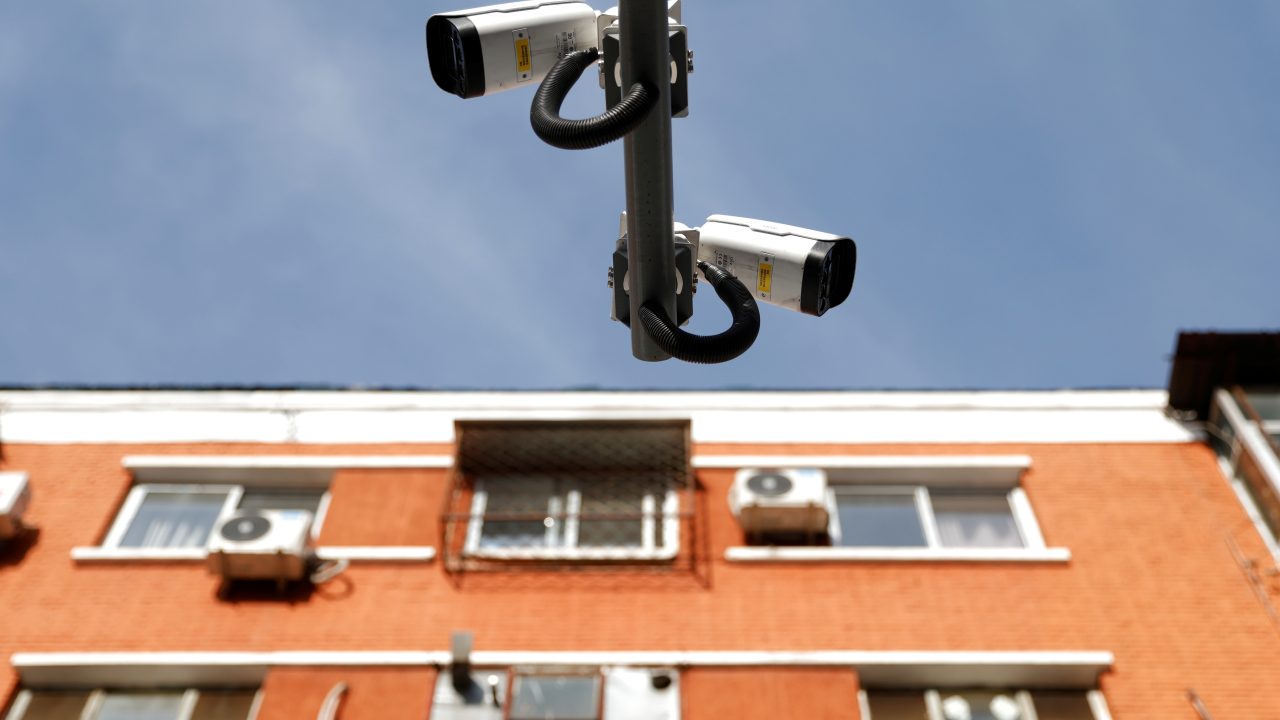 Uniview surveillance cameras overlook a street next to a residential building in Beijing, China on December 10, 2021. (Photo: Carlos Garcia Rawlins/Reuters)