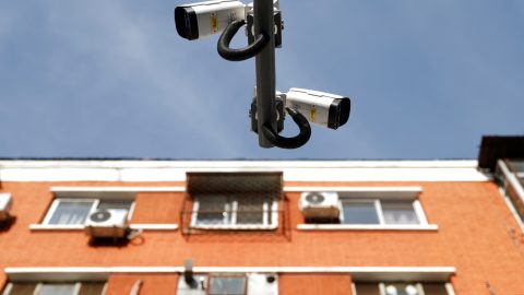 Uniview surveillance cameras overlook a street next to a residential building in Beijing, China on December 10, 2021. (Photo: Carlos Garcia Rawlins/Reuters)