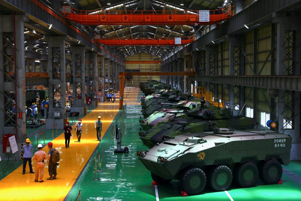 Staff members work on the production line of Taiwan military s latest armoured vehicle the CM "Clouded Leopard" in Nantou