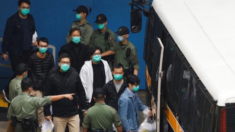 Pro democracy activists Ventus Lau Wing hong Kwok Ka ki Lam Cheuk ting and Raymond Chan Chi chuen walk to a prison van to head to court with other activists over a national security law charge in Hong Kong