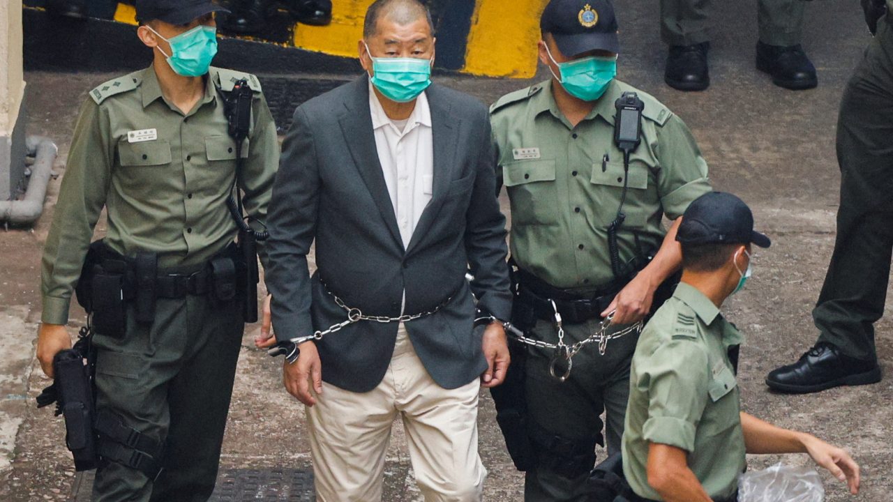 Apple Daily founder Jimmy Lai walks to a prison van in Hong Kong on December 12, 2020. (Photo: Tyrone Siu/Reuters)