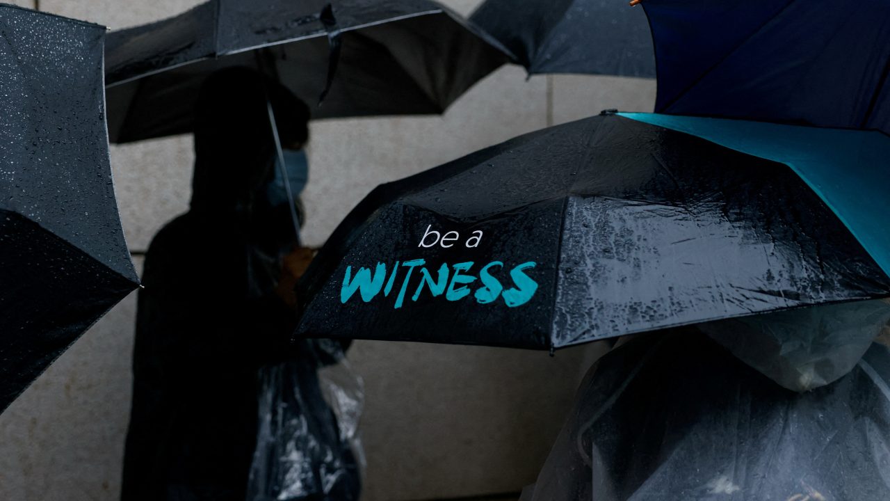 People queue to enter the West Kowloon Magistrates’ Courts building as Jimmy Lai takes the witness stand for the first time in his national security collusion trial in Hong Kong on November 20. (Photo: Tyrone Siu/Reuters)