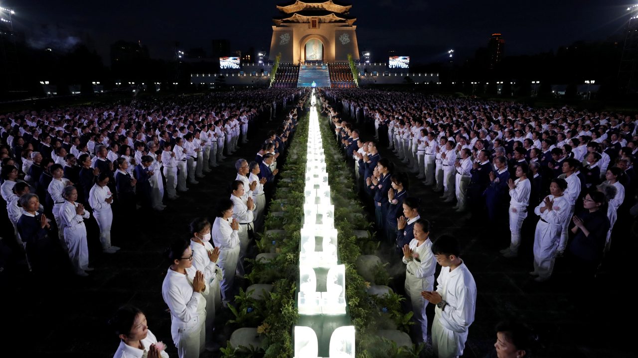 Members of the Buddhist Tzu Chi Foundation pray during a ceremony to commemorate the birth of Buddha at the Liberty Square in Taipei