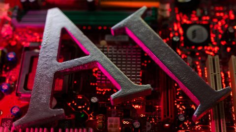 Illustration shows AI Artificial Intelligence letters and computer motherboard