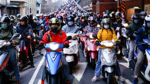 People on motorbikes wait at a traffic light during morning rush hour in Taipei on January 10. (Photo: Ann Wang/Reuters)