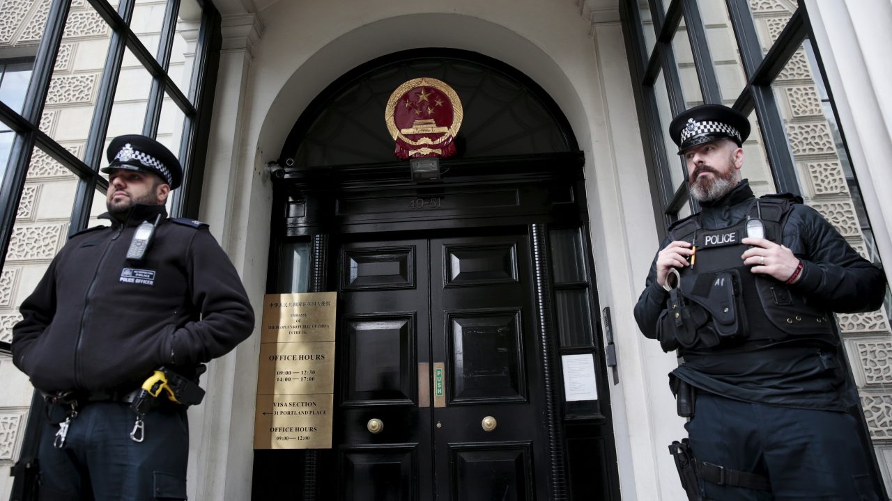 Policemen stand guard outside the Chinese Embassy in London Britain