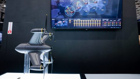 A model of Tron Future’s T Interceptor CS drone is displayed next to a simulation screen during the Taipei Aerospace and Defence Technology Exhibition